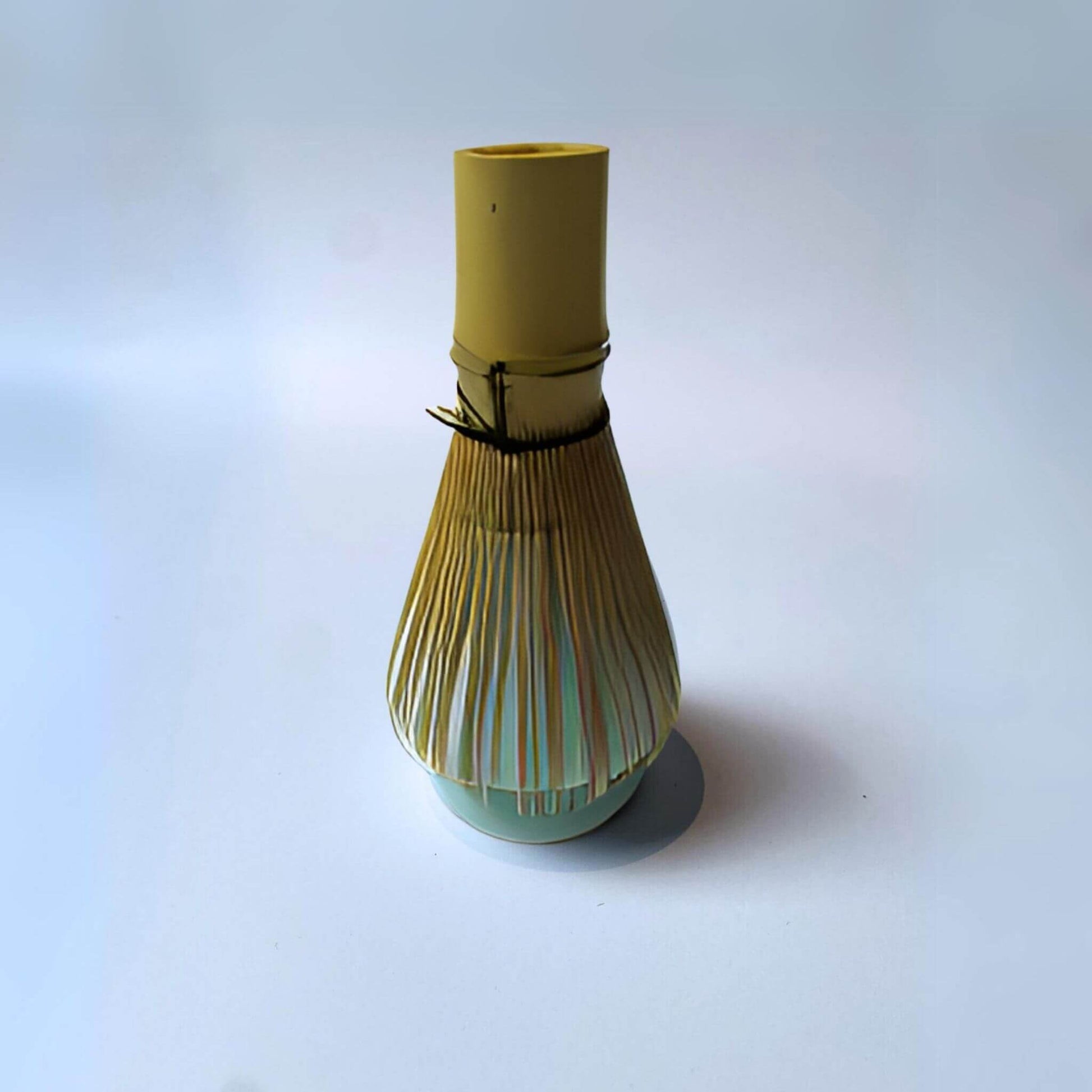 matcha whisk on a blue matcha whisk holder